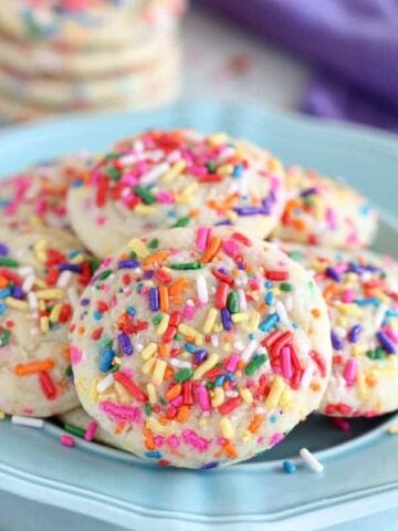 Blue plate topped with sprinkle sugar cookies.