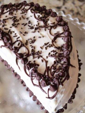Half birthday cake on a glass plate.