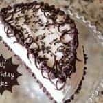 Half birthday cake on a glass plate.
