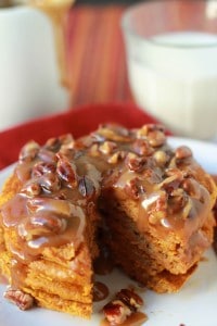 Stack of pancakes topped with pecan praline syrup.