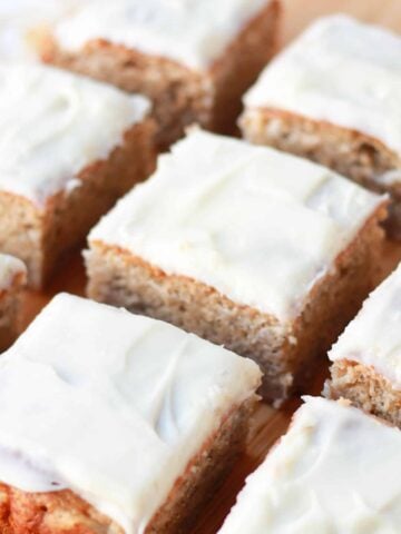Slices of cake on a wooden board.