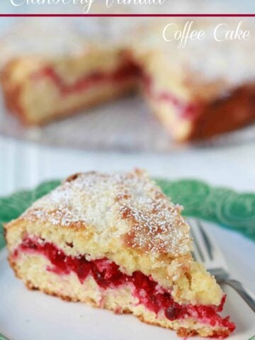 Slice of cranberry cake on a green and white plate.