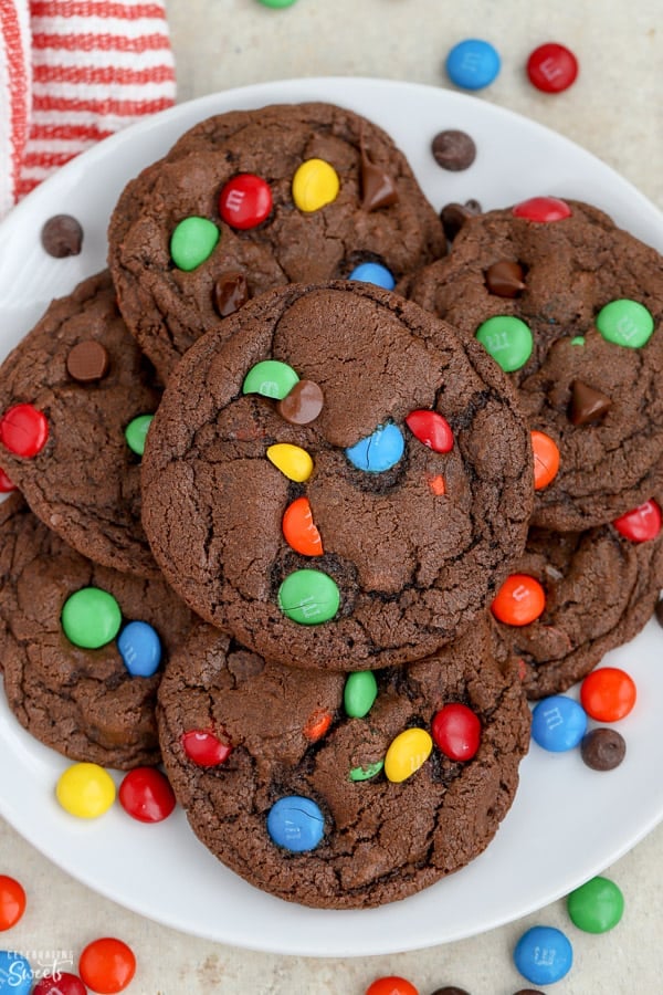 Chocolate M&M Cookies on a white plate.