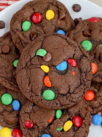 Chocolate M&M Cookies on a white plate.