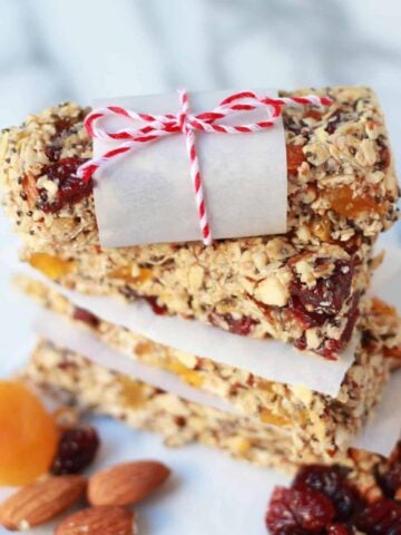 Stack of granola bars on pieces of parchment paper.