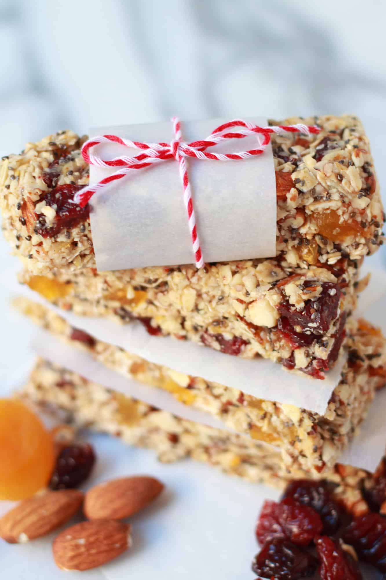 Stack of granola bars on pieces of parchment paper.