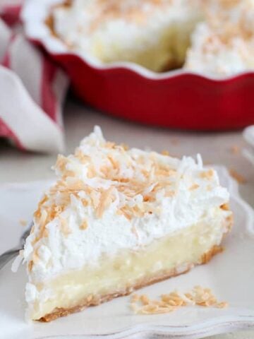 Coconut Cream Pie on a white plate.