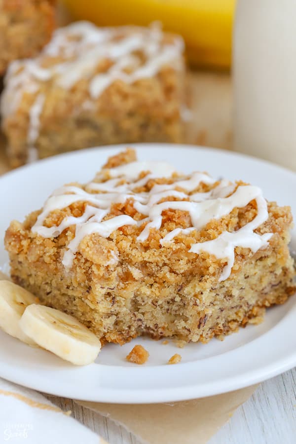 Slice of banana crumb cake on a white plate.