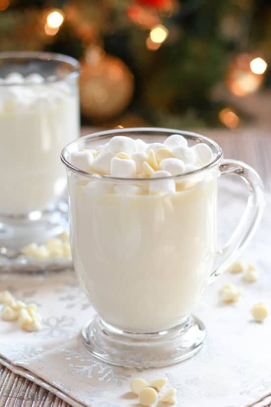 Glass mug filled with white hot chocolate.