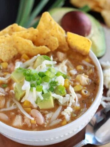 Bowl of chicken chili with tortilla chips.