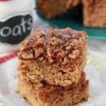 Two slices of cake topped with pecans.