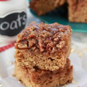 Two slices of cake topped with pecans.