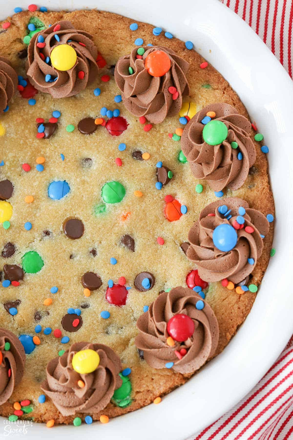Cookie cake decorated with chocolate frosting and M&M's