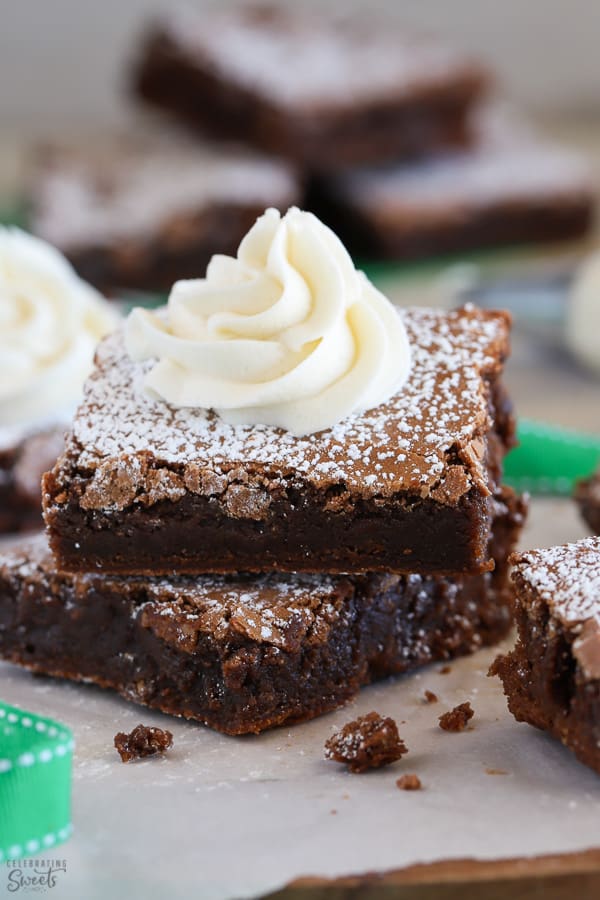 Two Guinness Brownies topped with a swirl of buttercream frosting. 