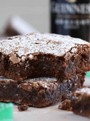 Two Guinness Brownies topped with powdered sugar.