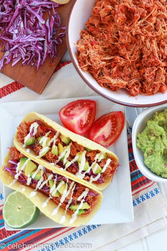 Chicken tacos on a white plate.