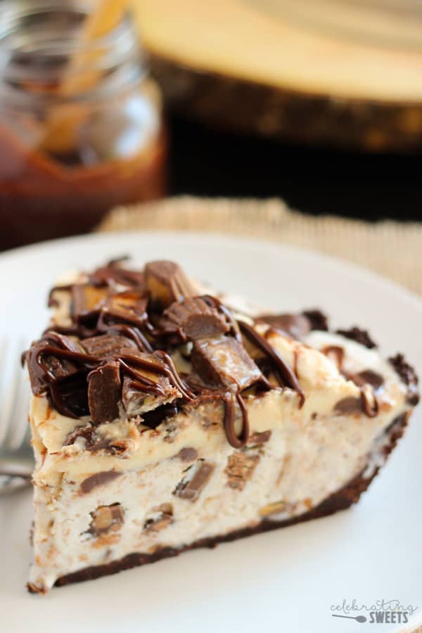 Peanut butter ice cream pie topped with fudge sauce and chopped peanut butter cups.