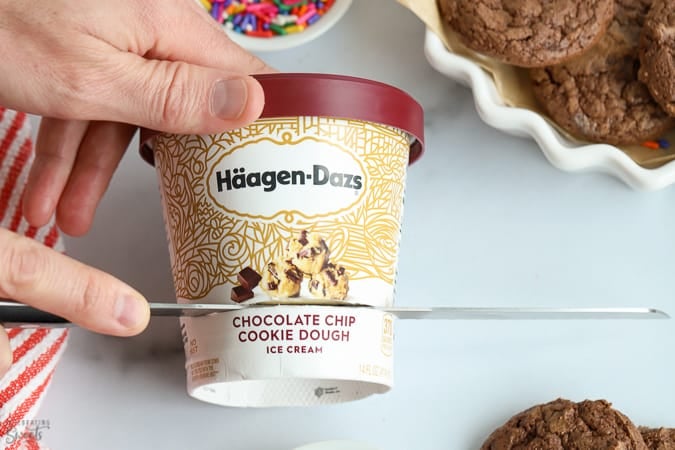 Haagen Dazs ice cream being cut for ice cream sandwiches.