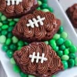 Football shaped brownies on top of green M&M's.