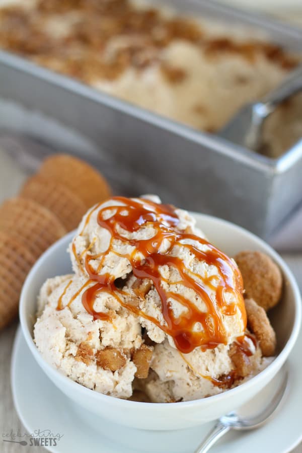 Scoops of apple pie ice cream in a white bowl with caramel sauce.
