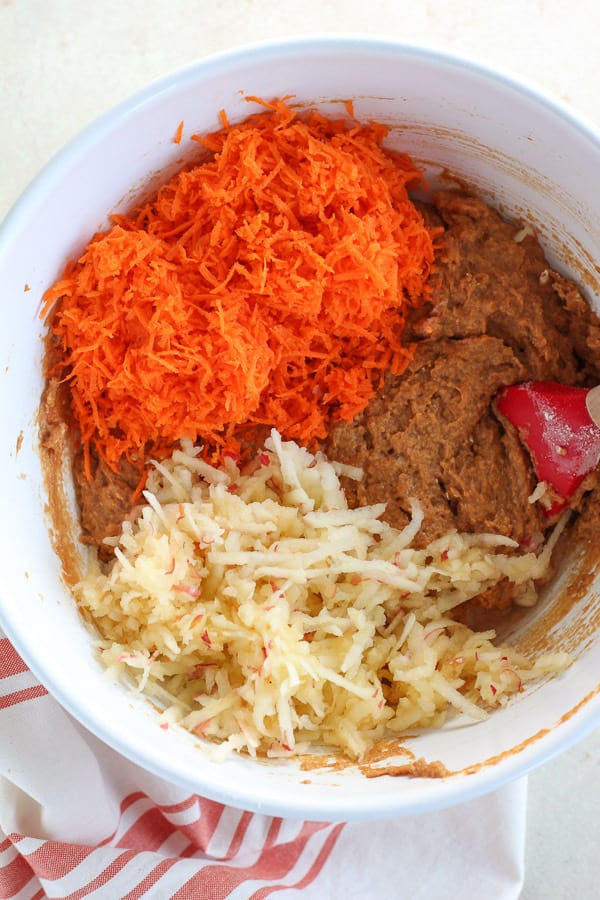Shredded carrots and grated apples in pumpkin muffin batter.