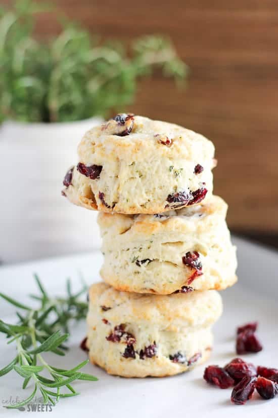 Stack of three cranberry muffins on a white plate.