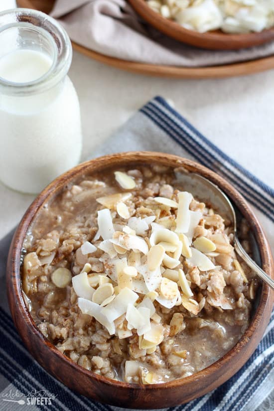 Bowl of oatmeal topped with coconut and almonds. 