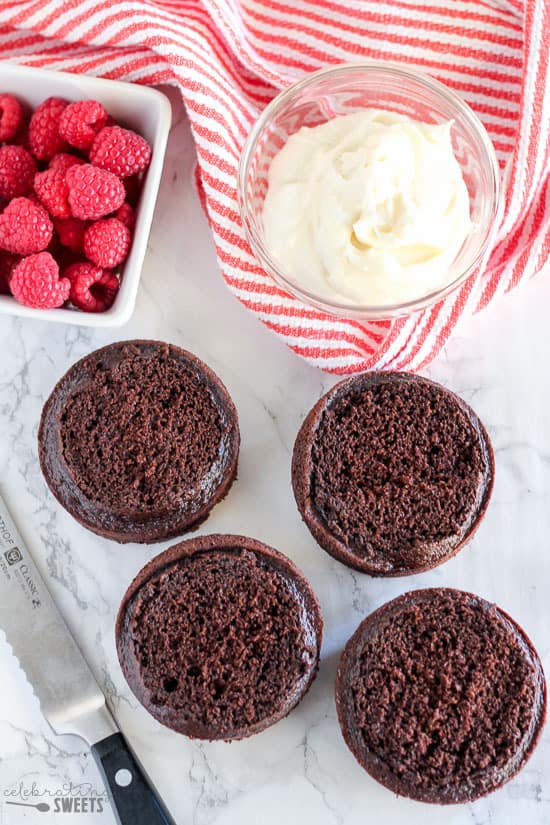 Chocolate cakes with a bowl of vanilla frosting.