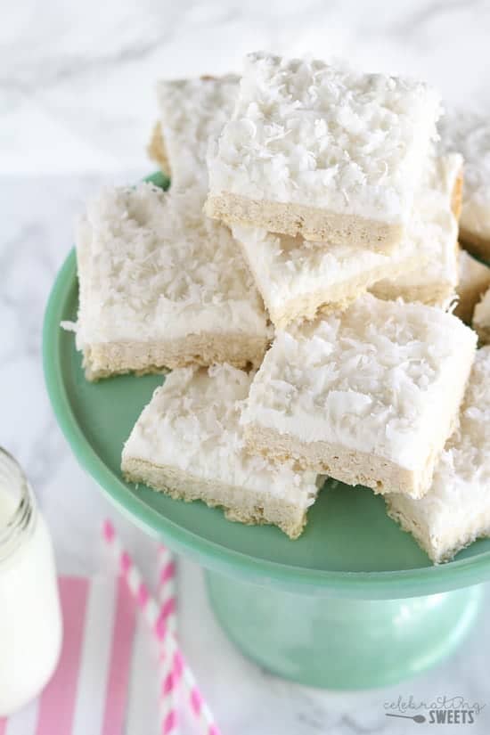 Stack of sugar cookie bars topped with coconut.