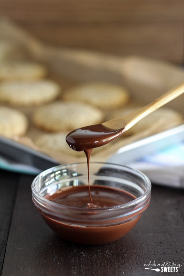 Bowl of chocolate ganache with a wooden spoon.