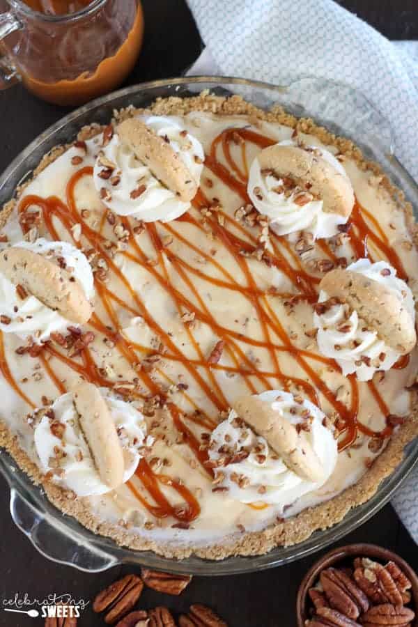Ice cream pie topped with caramel sauce and cookies.