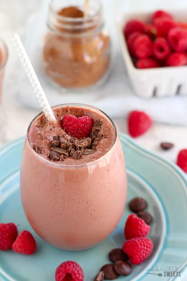 Chocolate smoothie topped with raspberries. 