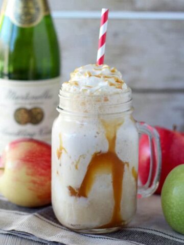 Apple cider float in a mason jar with caramel sauce.