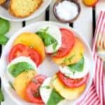 Sliced peaches, tomato, and mozzarella topped with basil.