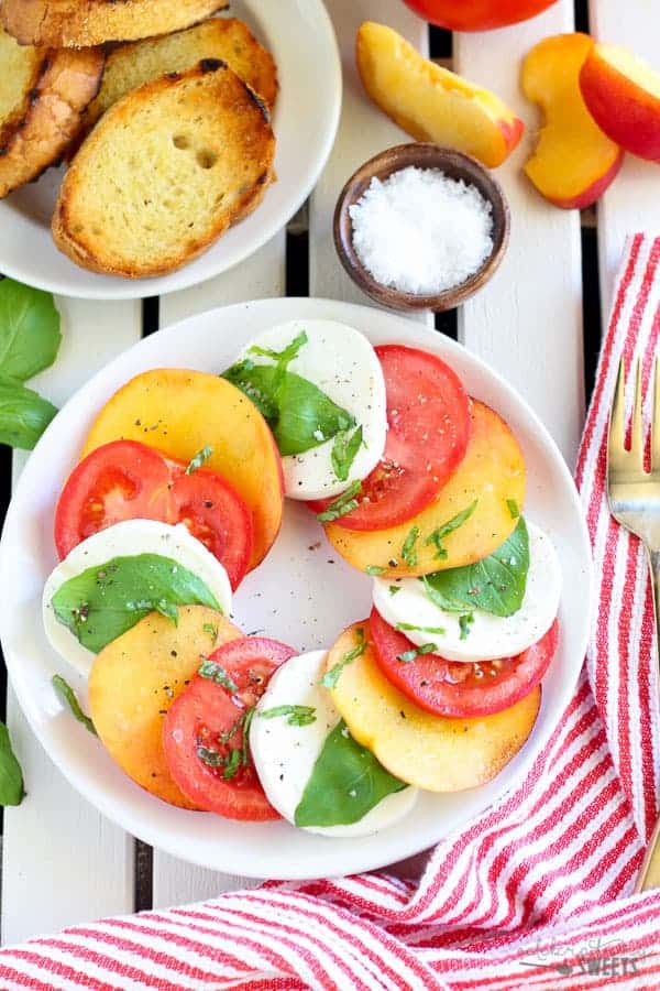 Sliced peaches, tomato, and mozzarella topped with basil. 