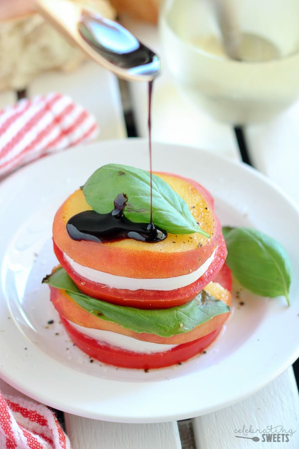 Sliced peaches, tomato, and mozzarella topped with basil.