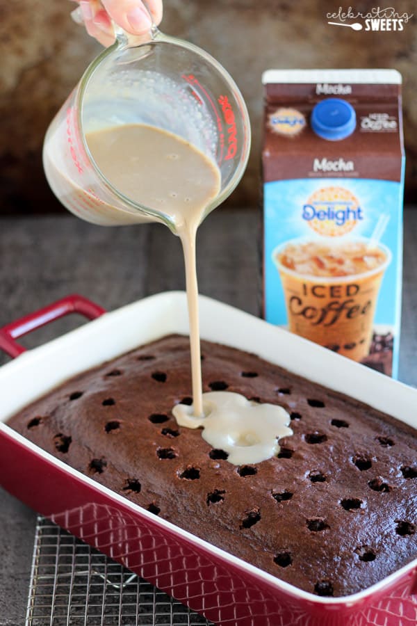 Pouring liquid over a chocolate poke cake.