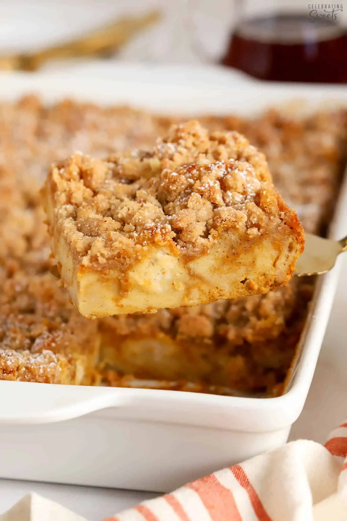 Slice of pumpkin french toast casserole on a gold spatula.
