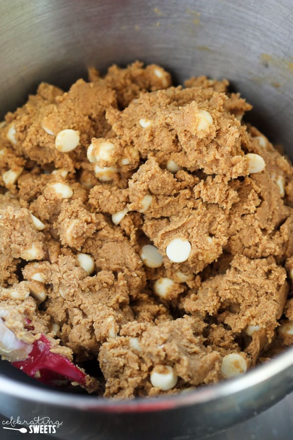 Cookie dough in a bowl with white chocolate chips.