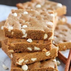 Stack of gingerbread cookie bars filled with white chocolate chips.