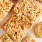 Closeup of a gooey peanut butter rice krispies treat topped with flaky sea salt.