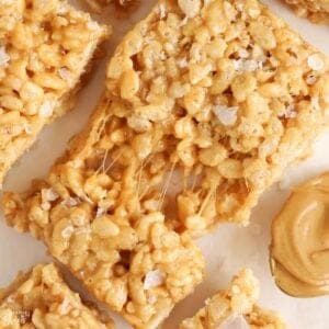 Closeup of a gooey peanut butter rice krispies treat topped with flaky sea salt.