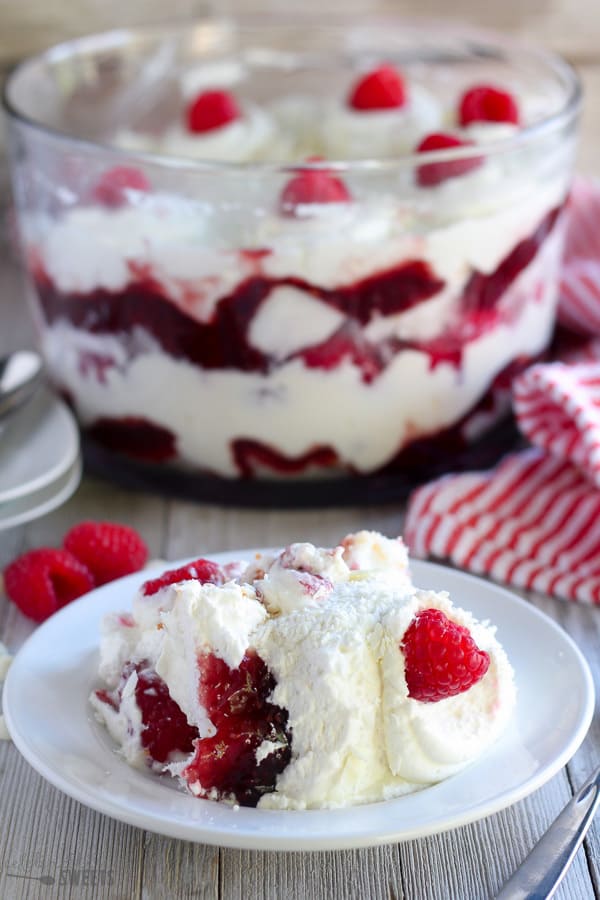 Trifle with cake, whipped cream, jam and raspberries.