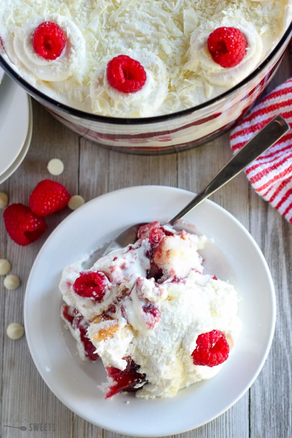 Trifle with cake, whipped cream, jam and raspberries.