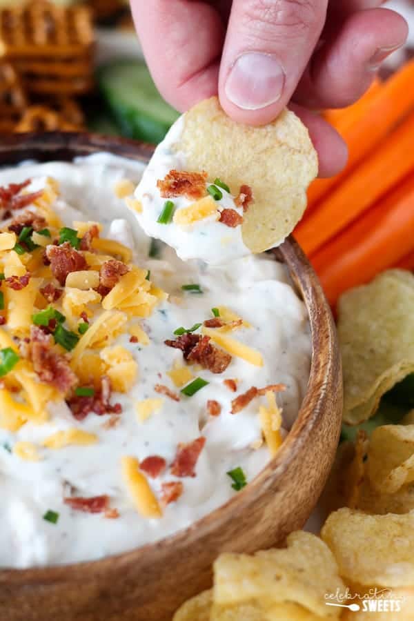 Chips and dip topped with bacon, cheese, and chives.
