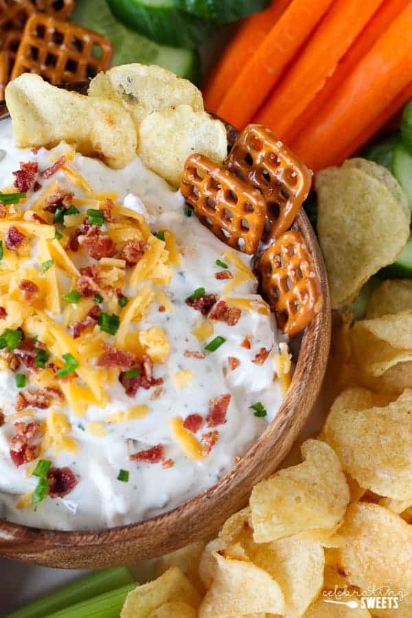 Chips and dip topped with bacon, cheese, and chives.