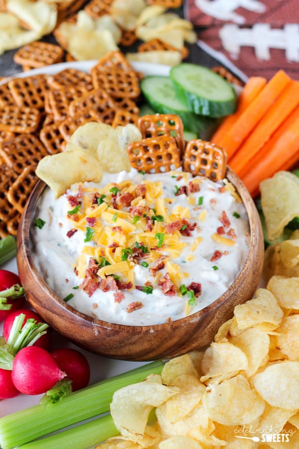 Chips and dip topped with bacon, cheese, and chives.