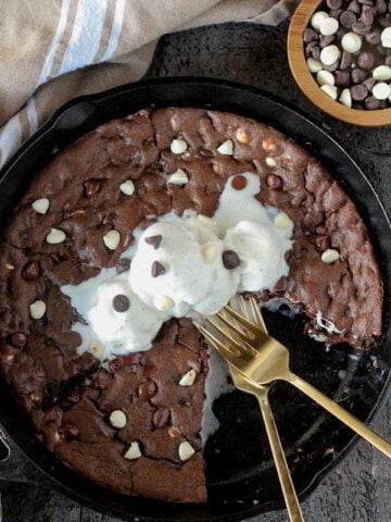 Chocolate skillet cookie topped with ice cream.