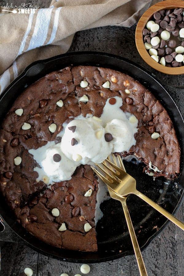 Chocolate skillet cookie topped with ice cream.