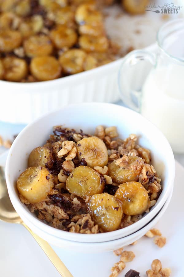 Baked oatmeal topped with sliced bananas in a white bowl.